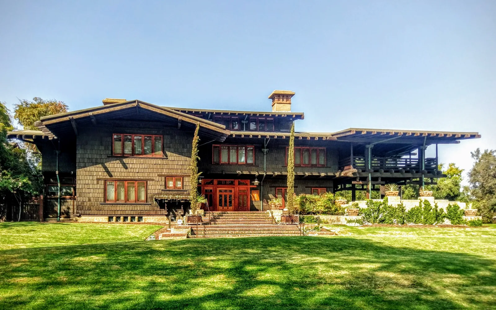 The front exterior of the Gamble House, showing the distinctive Craftsman architectural style